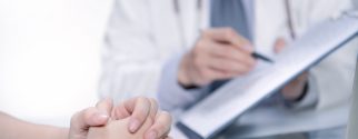 Medical doctor and patient discussing and consulting in hospital examination room